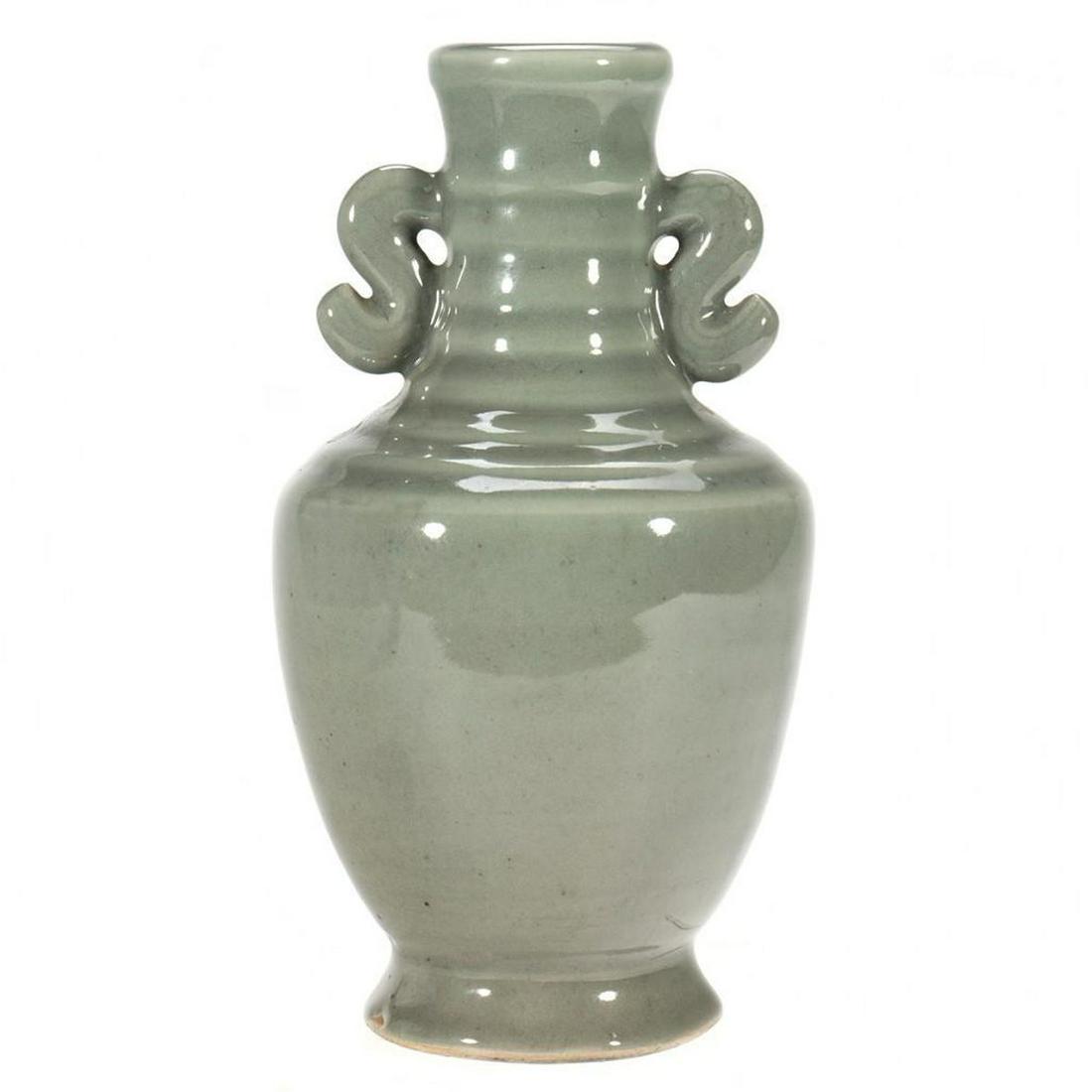 Deco Pottery Vase.: The grey-green stick neck vase with scrolled handles. 8in. (20cm) h. Condition: Minor chip to edge of foot.