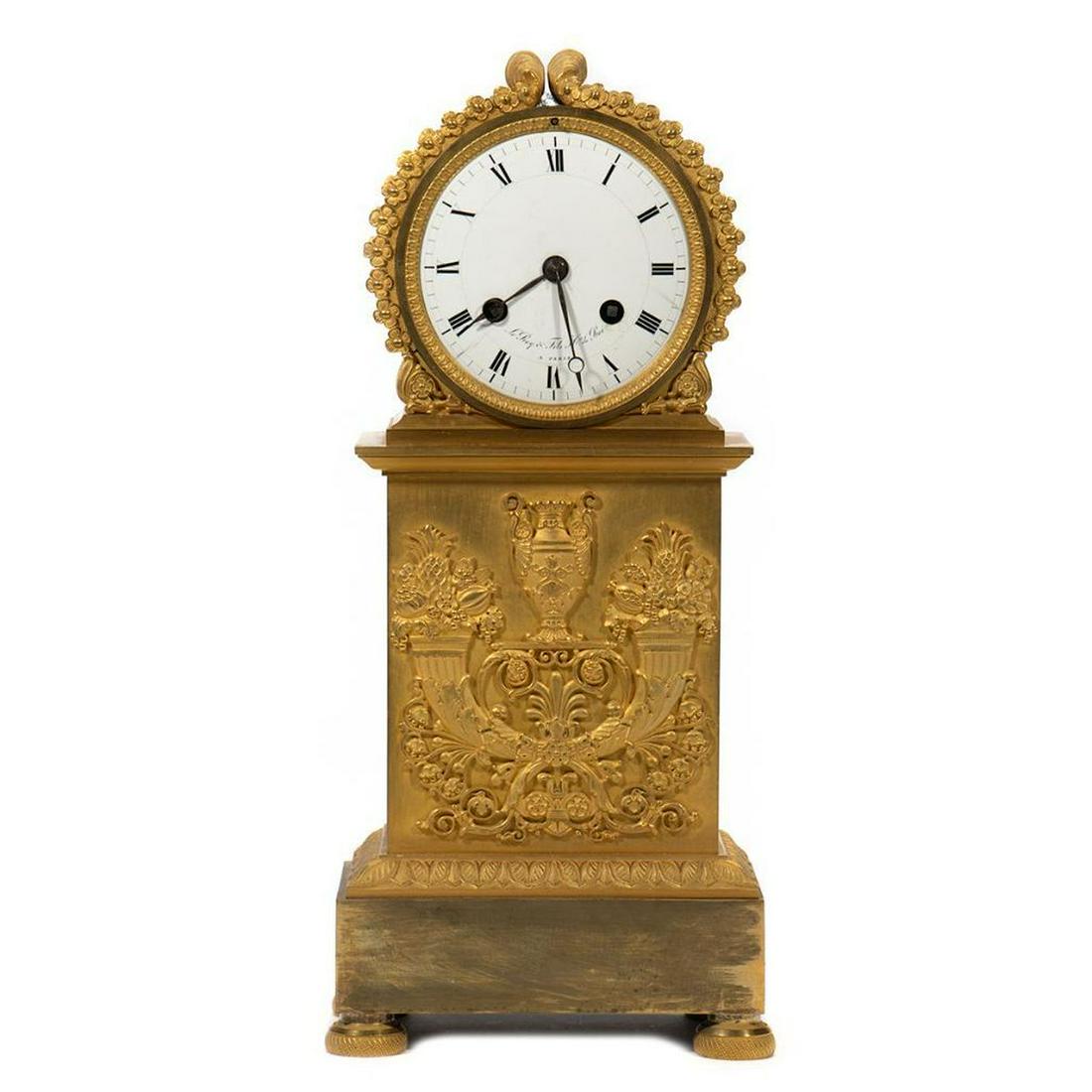 Leroy & Fils French Empire Gilt Mantel Clock: The clock face inscribed LeRoy & Fils a Paris enclosed in a gilt acanthus frame raised on a plinth base with abundant cornucopia and Classical urn. 15in. h. Condition: Very good. Clock works not war