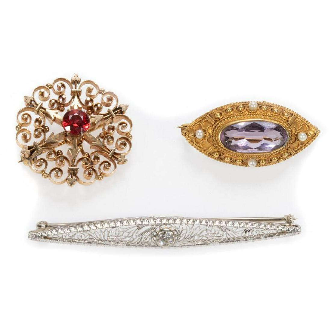Antique diamond, gem-set , 14k gold bar pins: one white gold filigree with a transitional round-cut diamond weighing approximately 0.15ct, length 2 1/4in.; a yellow gold navette pin with amethyst and seed pearl, length: 1 1/4in; and a red stone s
