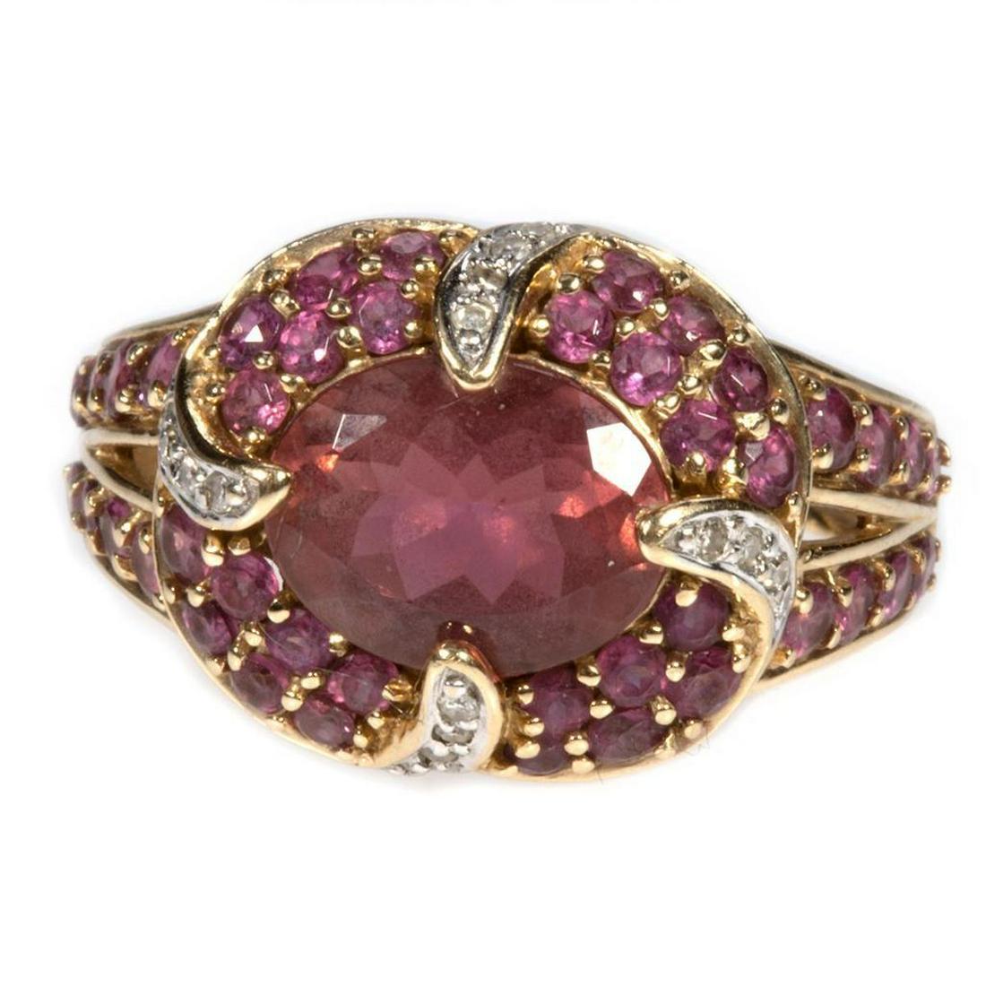 Garnet, pink tourmaline, diamond and 14k gold ring: centering an oval-shaped rhodolite garnet measuring 10 x 8.5 x 4.2mm, accented by round pink tourmalines and 16 single-cut diamonds weighing an estimated 0.04ct; weighing 6.1 grams; size: 7 1/2