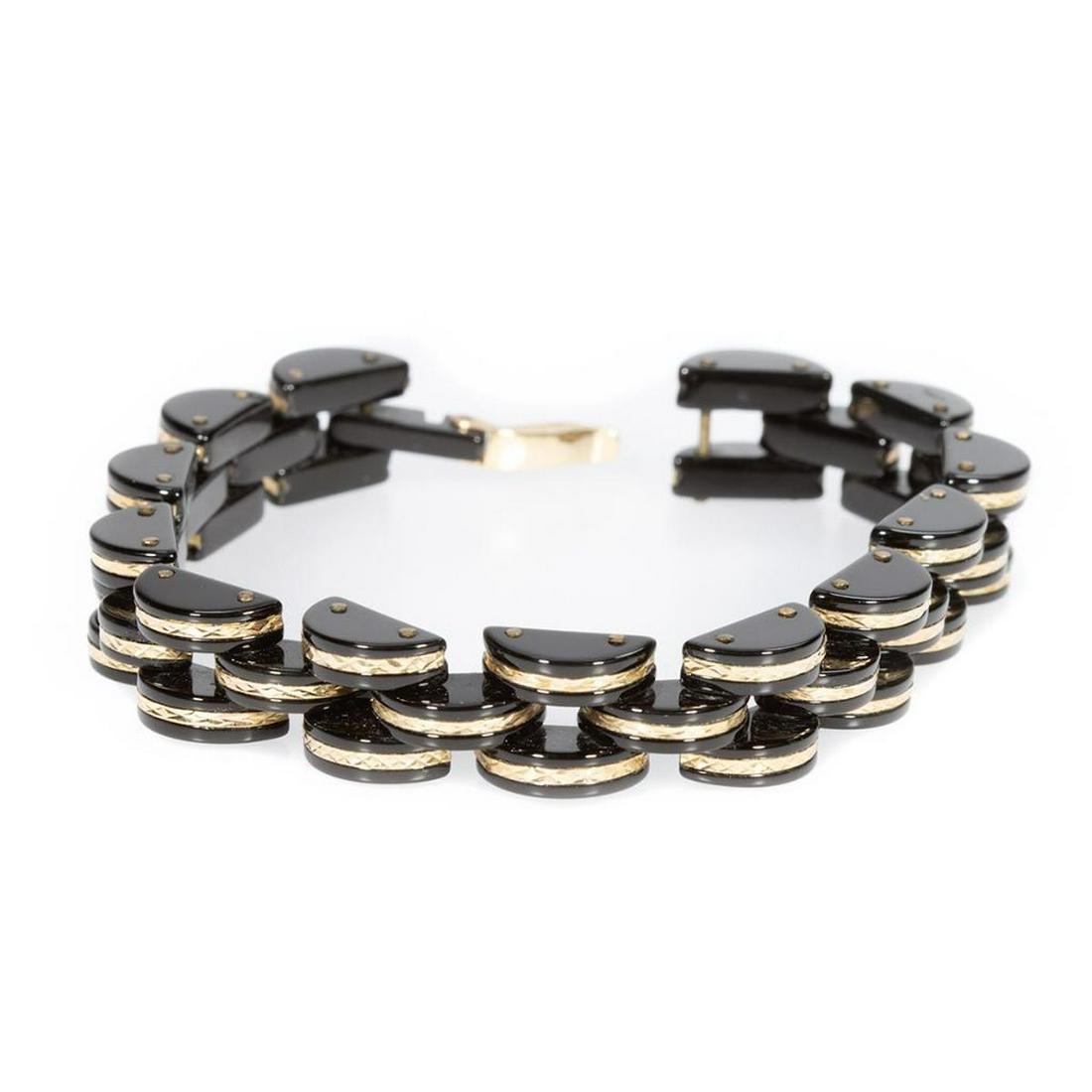 Onyx and 14k gold link bracelet: hinged onyx links accented by patterned gold; length: 7 3/4in.