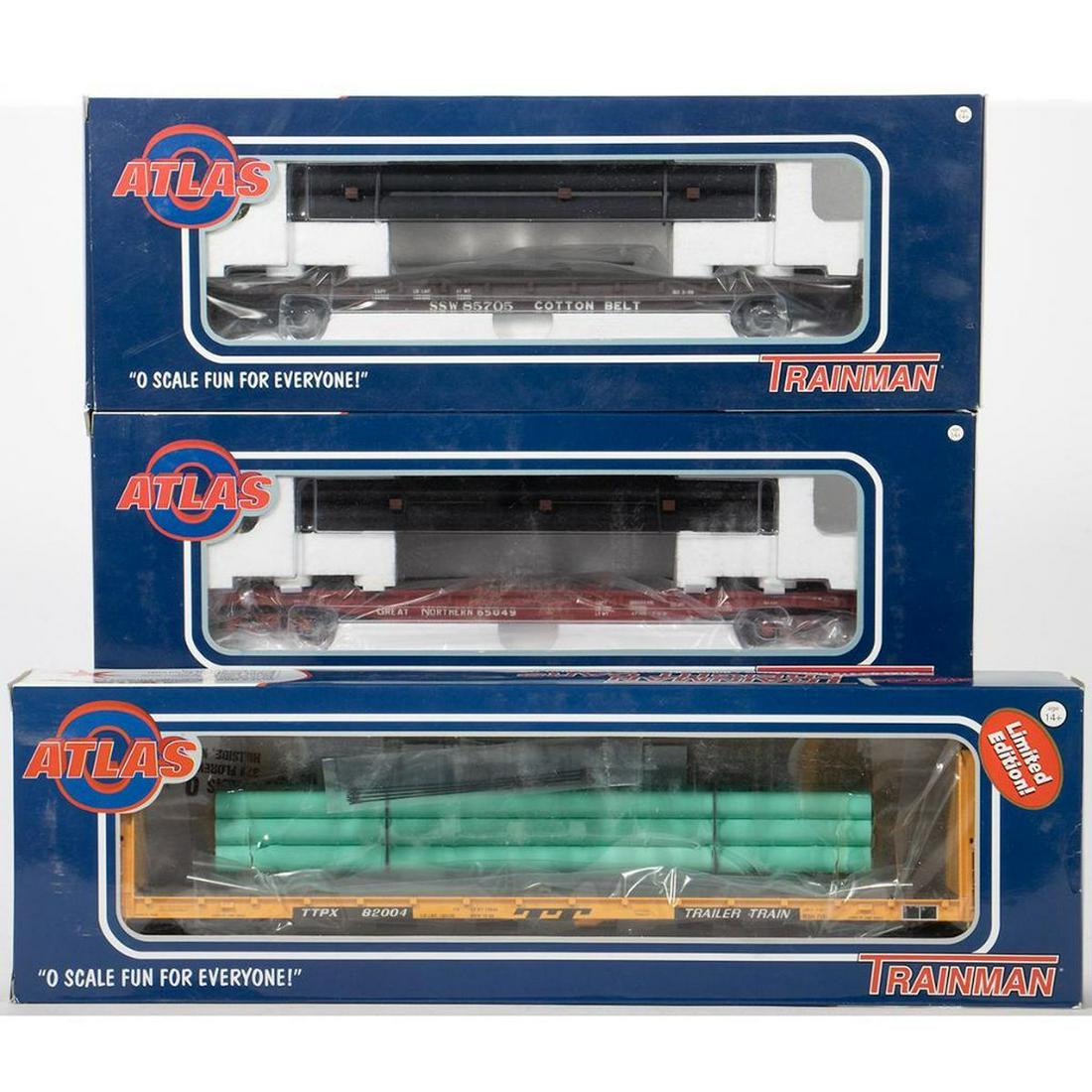 Atlas O Gauge. Flat Cars. Trailer Train, Cotton Belt,: 20017725; New Old Stock; Bulhead Flat Car Trailer Train Road Number 82004 with green pipe load [2 Rail] 2002058-1; New Old Stock; 52 foot 6 inch Flat Car Cotton Belt Road Number 85705 with black pipe 