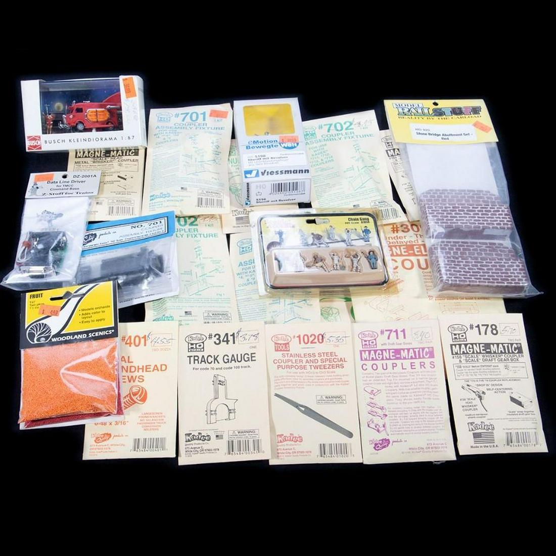 HO Scenery parts, couplers and Digitrax components: HO5198; New Old Stock; Sheriff with revolver with LED HO7623; New Old Stock; Merry Christmas diorama HO920; New Old Stock; Stone Bridge Abutment Set - Red HO920; New Old Stock; Stone Bridge Abutment S