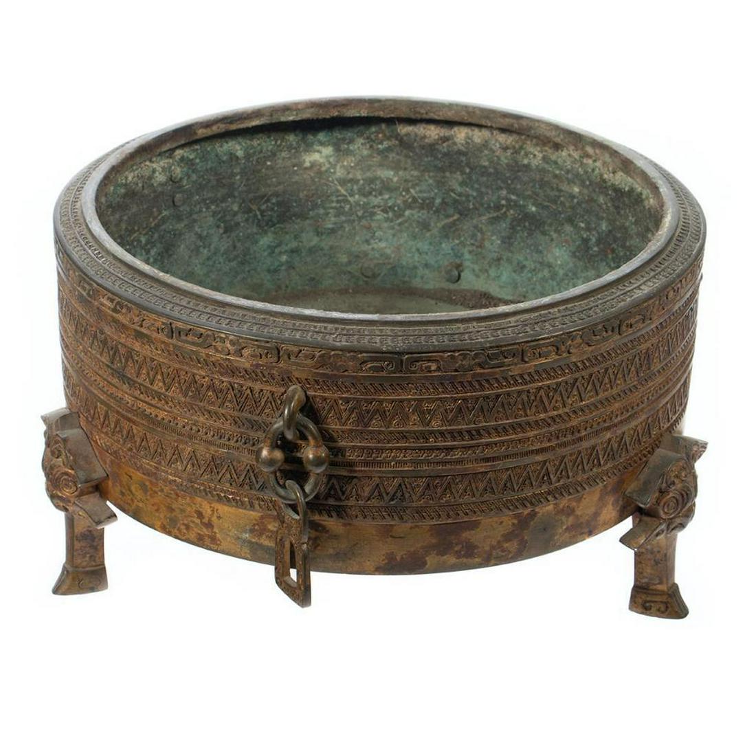Asian Archaic Style Bronze Censer: Asian Archaic Style Bronze Censer. Decorated with geometric banding raised on hoof style feet. 7in. H 11in diameter