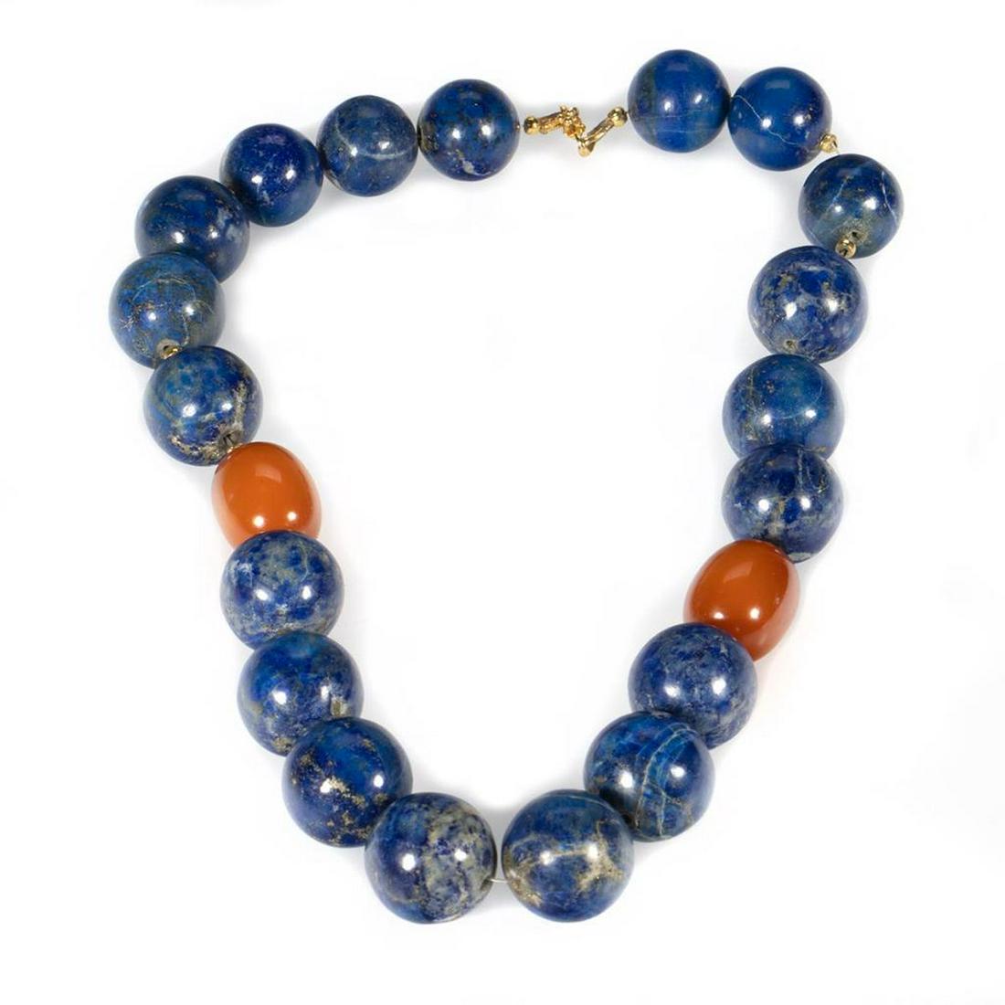 Lapis lazuli, amber and 18k gold beaded necklace: lapis beads measuring approximately 12.2mm, completed by a gold hook clasp; length: 21in.