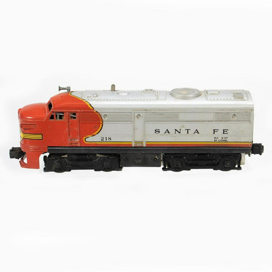 Lionel Postwar 218 Santa Fe Alco Diesel: Lionel Postwar 218 Santa Fe Alco Diesel. Horn intact. Bottom of fron skirt cracked. Nose decal damaged. Trucks and couplers intact but there is rust n the wheels, pickups and frame of front truck. Dir