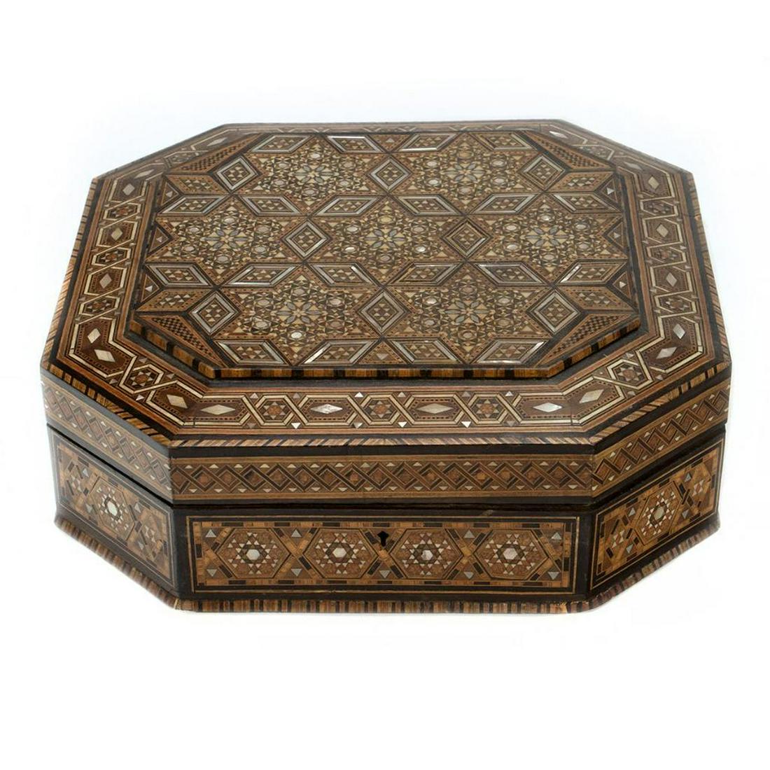 Indian Mother-of-Pearl Marquetry Box: The chamfered corner box with wood and mother-of-pearl geometric inlaid design, which continues to the inside rims and lid; silk and bead-embellished lining. 12" x 12" x 3 1/2". Condition: Several pie