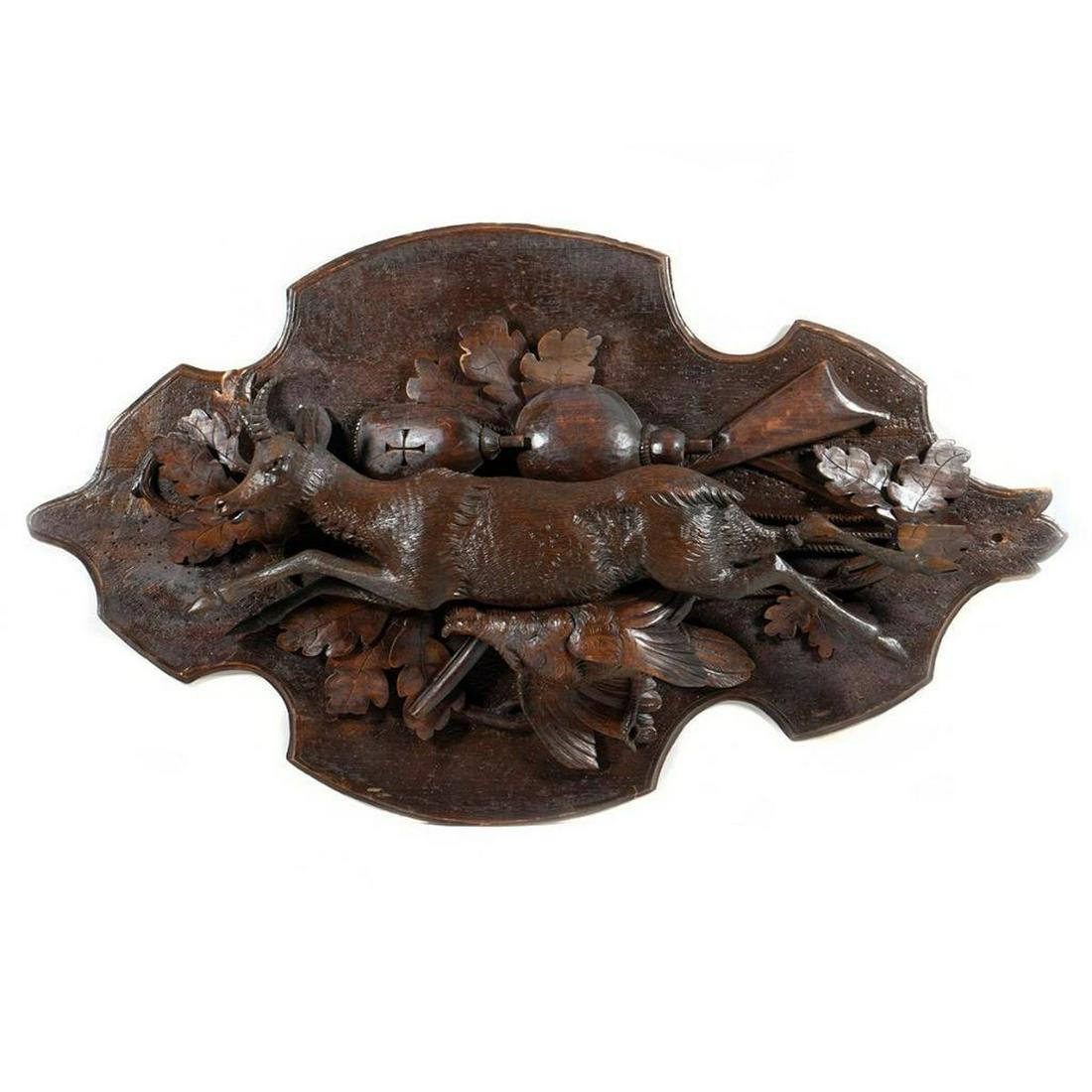 Pair Victorian Hunt Trophies: Each relief carved with a deer and quail above hunting equipment on oak clusters. 30in. h. 17in. w. Condition: very good.