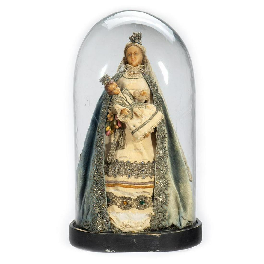 Victorian Wax Madonna and Child in Glass Dome: The Madonna figure has wax head and hands, and appears to have real human hair; her torso is stuffed and her skirt is on a paper form. She wears a crown, lace veil, velvet cloak and silk gown with sil