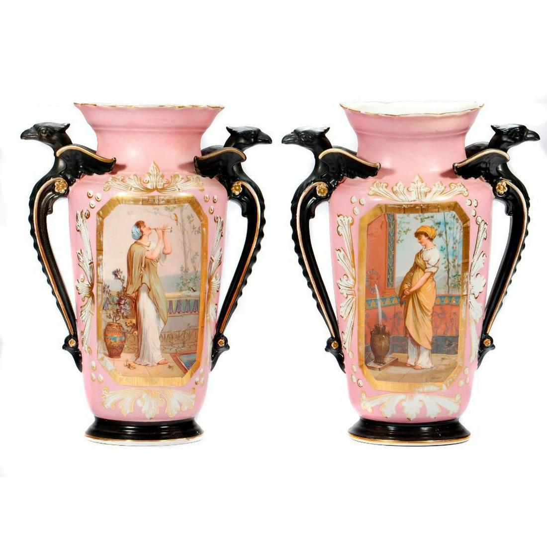 Pair of Neoclassical Style Pink Gilt Vases: With eagle-form handles and central tableaux of Classical women; unmarked. Each. approx. 13 2/8in. h. x 10in. w. Condition: One eagle with old repair to beak, and this vase rests at a very slightly fo