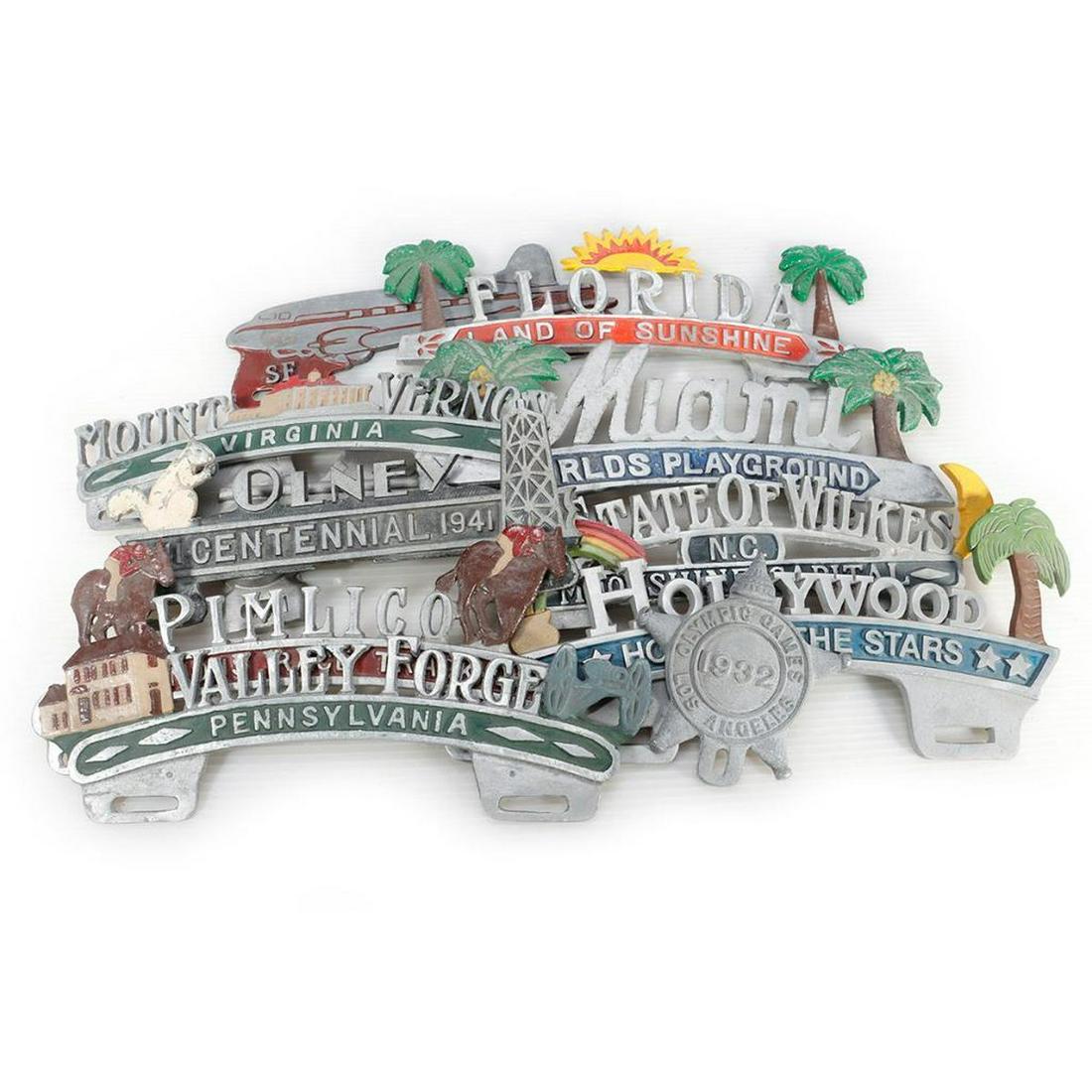 Ten Cast Aluminum License Plate Toppers and a 1932 Olympics Medallion (1 of 4)