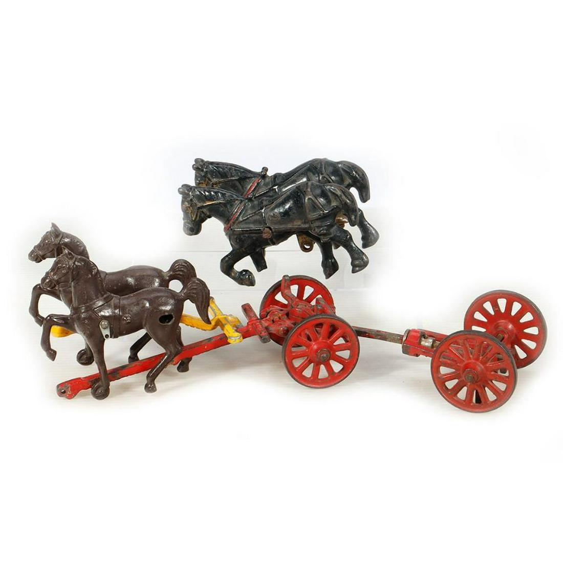 Cast Iron Toy parts. Horses and Trailer labeled "Arcade" and "McCormick Deering": Pair of Black Horses. Remains of decal Arcade Toy. Both horses are missing lower right front leg. Paint wear. Pair of Brown Horses. Yellow Bracket says "MADE IN USA". Paint wear. Trailer - no load. La