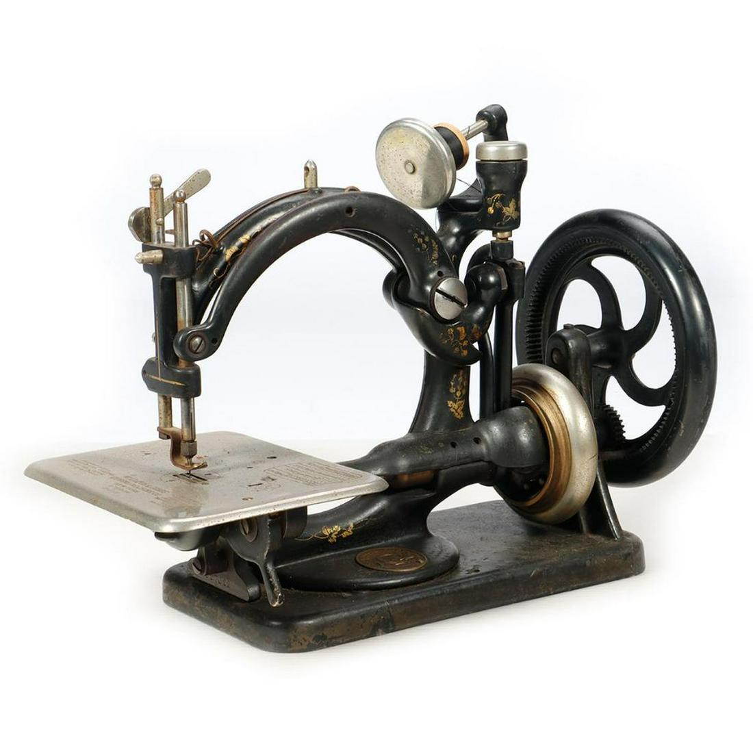 Wilcox & Gibbs Manual Sewing Machine Serial #A527022.: Wilcox & Gibbs Manual Sewing Machine. Serial # A 527022. Some gold decoration worn off. Dusty.