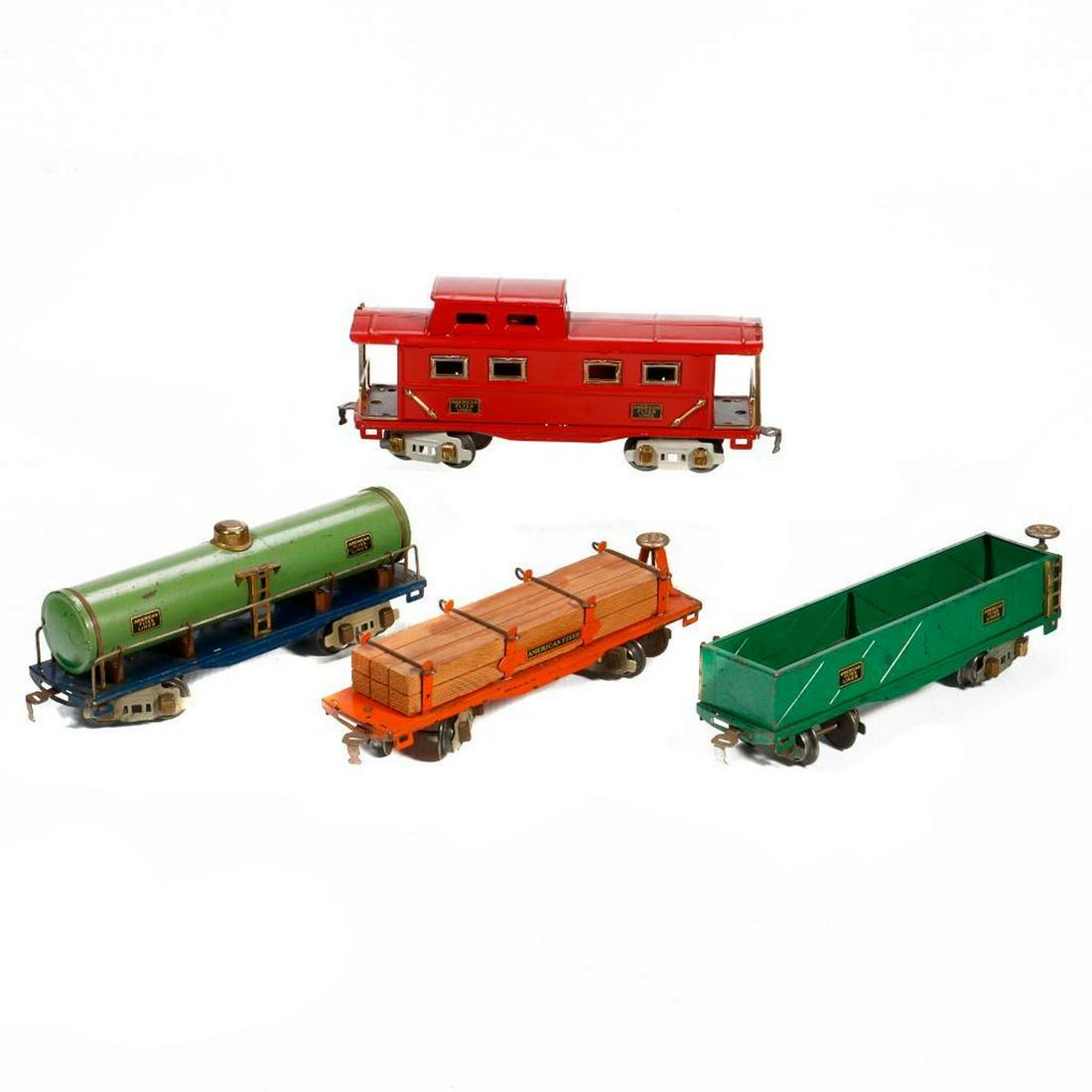 American Flyer O Gauge Freight Cars: American Flyer O Gauge Freight Cars: 3210 Tank Car. Green tank on blue base with copper supports. Trucks, steps, and couplers intact. Wear from use. 3216 Flat Car with Lumber Load. Orange chassis. Hol