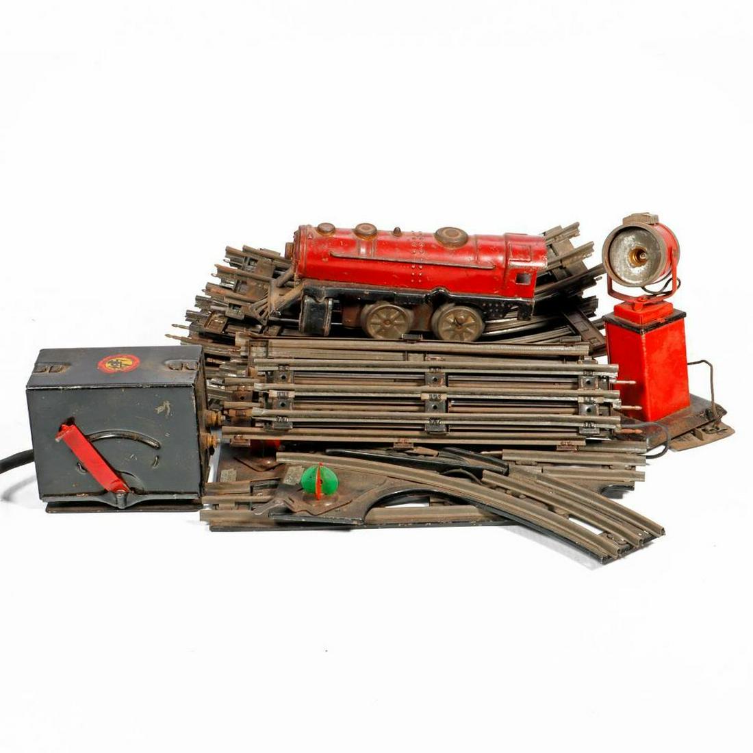 Joy Line WU Loco, Marx light, Xfmr, trk. Lionel 1024 switches.: Marx O Gauge Joy Line red wind up 0-4-0 locomotive with key. Domes, bell, hand rails and head light intact. No side rods. Has key. Paint has scratches and wear. Dirty. Flood light. Base, housing, term