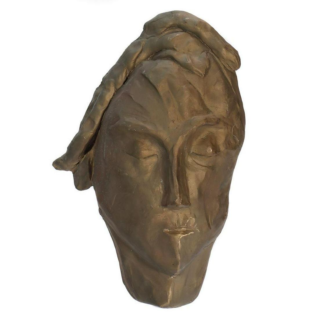 Eleen Auvil (1927 - 2022).: Artist: Eleen Auvil (1927 - 2022). Title/Subject: Elongated mask. Size: 12 6/8in. x 7 3/4in. Year Created: Undated. Signature: Unsigned. Medium/Ground: Cast brass. Condition good, patina. Condition Re