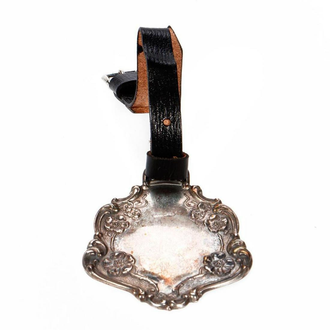 Webster Art Nouveau sterling silver luggage tag.: On a leather strap, measuring approximately 4in. (oxidized). Condition Report: All lots are sold as is and where is. Turner Auctions + Appraisals, LLC provides condition reports upon request to aid in