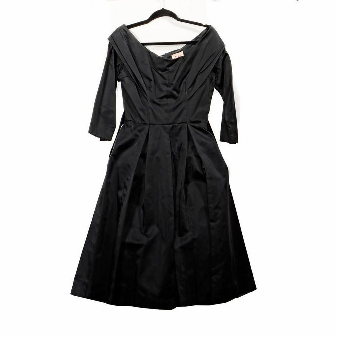 Vintage Black Satin Dress, c. 1950s-1960s.: Tea-length skirt, fitted sleeves/bodice, attached crinoline/underskirt label "By Tobie/ New York". A small/medium size, shoulders approx. 15 1/2in; chest approx. 18in; waist approx. 14in; length 41in.