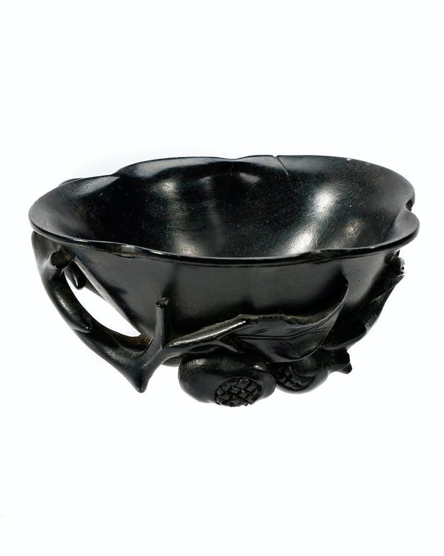 Chinese Carved Hardwood Libation Cup.: The cup with foliate form with branch, blossom, and bud decoration; 1 5/8in h x 4in l. Condition: tip of petal broken off; there is a small scratch and ding at rim; the inside of cup shows wear. FROM 