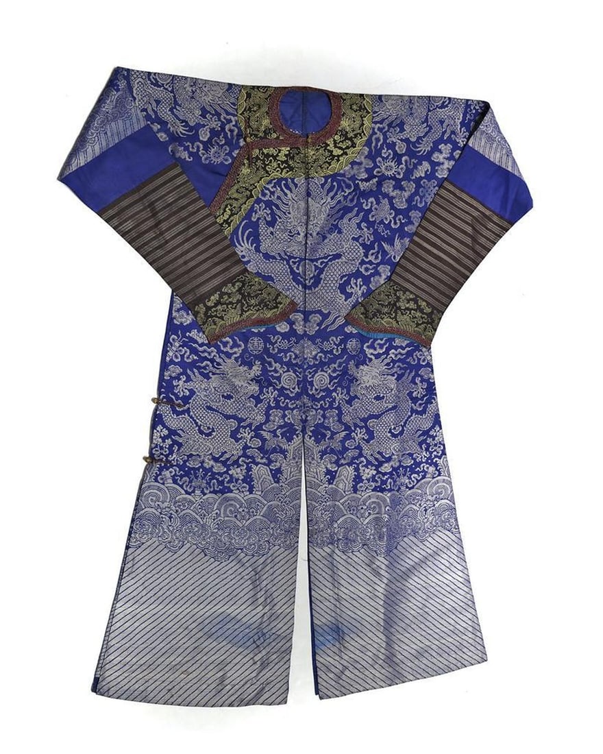 Manchu Man's Dragon Brocade Court Robe, c. Early 20th Century.: The semiformal court robe of blue silk brocade with contrasting sleeve segments; overlap closure with metal buttons; cuffs lined in blue silk; blue silk border lining inside; open shoulders, chest app