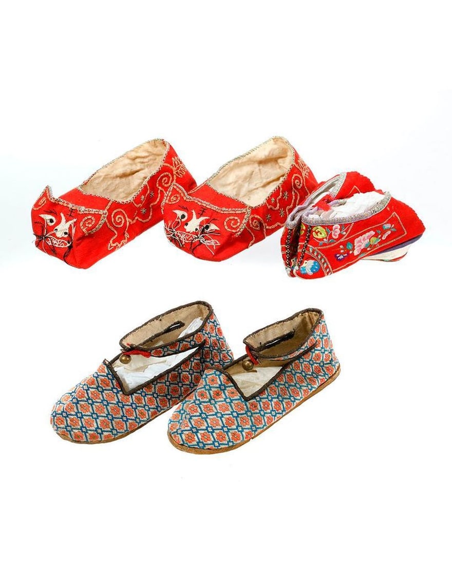 Two Pairs of Chinese Child/Lotus Slippers.: A pair of vintage brocade rigidleather sole ankle strap slippers (5 1/2in); and a pair of embroidered red cloth slippers with feline faces (5 3/4in).Together with a pair of souvenir embroidered red si