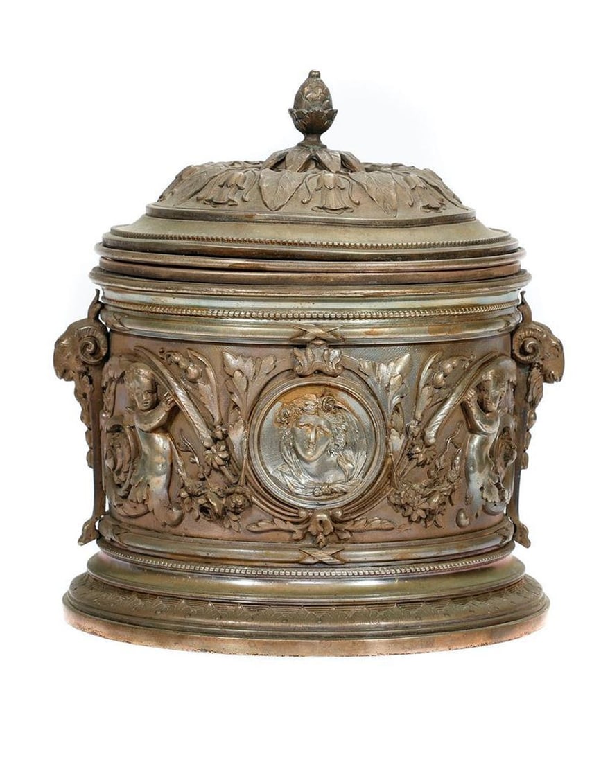 Ornate White Metal Jar.: The caddy/jar with a floral-decorated fitted finial lid. The jar with putti and classical goddess medallions, ram's head handles; the domed lid with acanthus leaves. Stamped on base: "AA [in diamond].