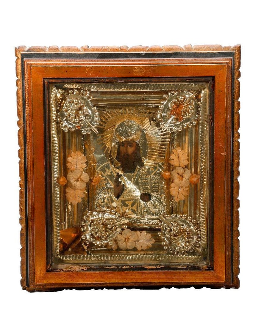 An Icon of Christ with Foil Oklad, in Kiot.: Eastern Europe, 19th/20th Century. An icon of Christ as the King of Kings, painted on wood, with ornate foil oklad embellished with faux flowers/leaves, in shadowbox frame/kiot. Overall frame 16 1/2" 