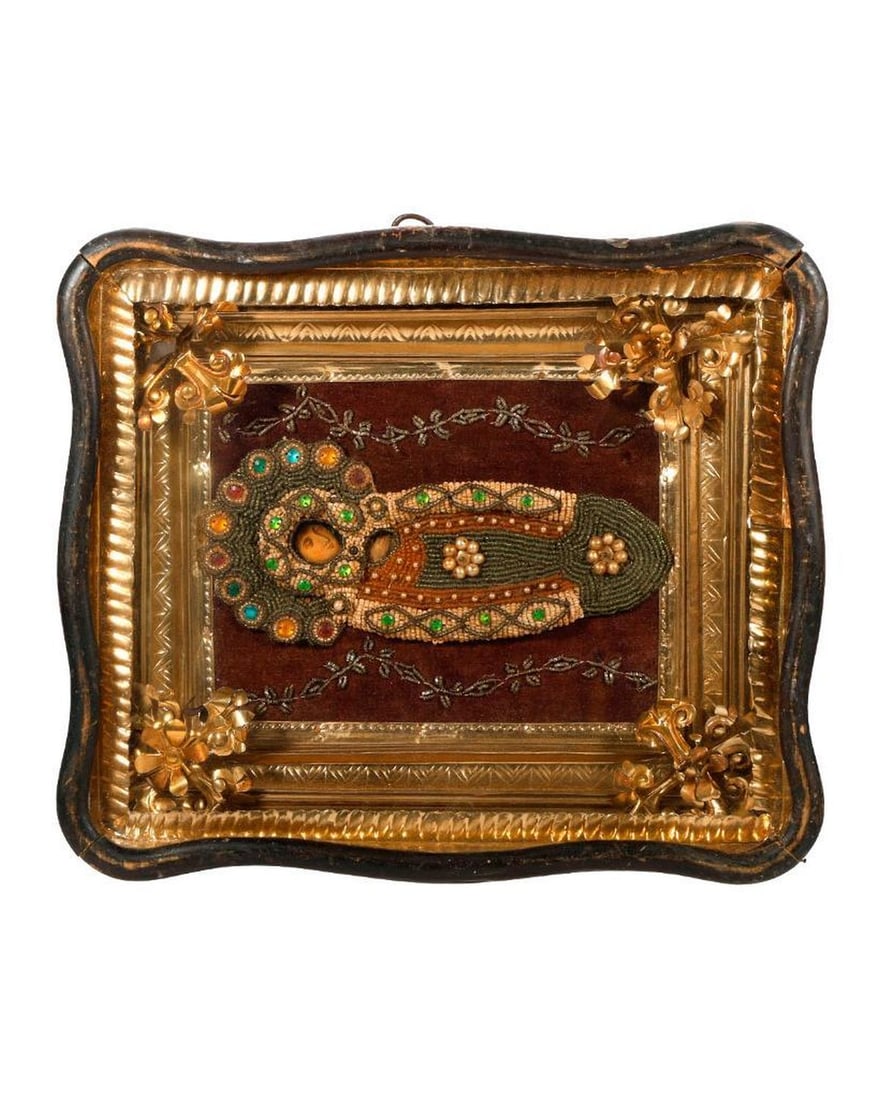 An Icon of the Theotokos with Beaded Shroud, in Kiot.: Eastern Europe, 19th/20th Century. An icon of the Dormition of the Theotokos, Mother of God, painted on wood, with beaded and faux jeweled shroud, mounted on embroidered brown velvet, with what appear