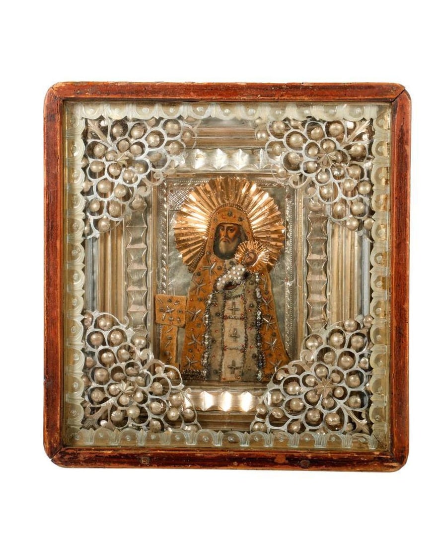 An Icon of Saint Simeon and the Christ Child, in Kiot.: Eastern Europe, 19th/20th Century. A painted icon of Saint Simeon with the Christ Child, the garments beaded and embroidered velvet, with a foil halo and an ornate foil oklad/liner, white-painted deco