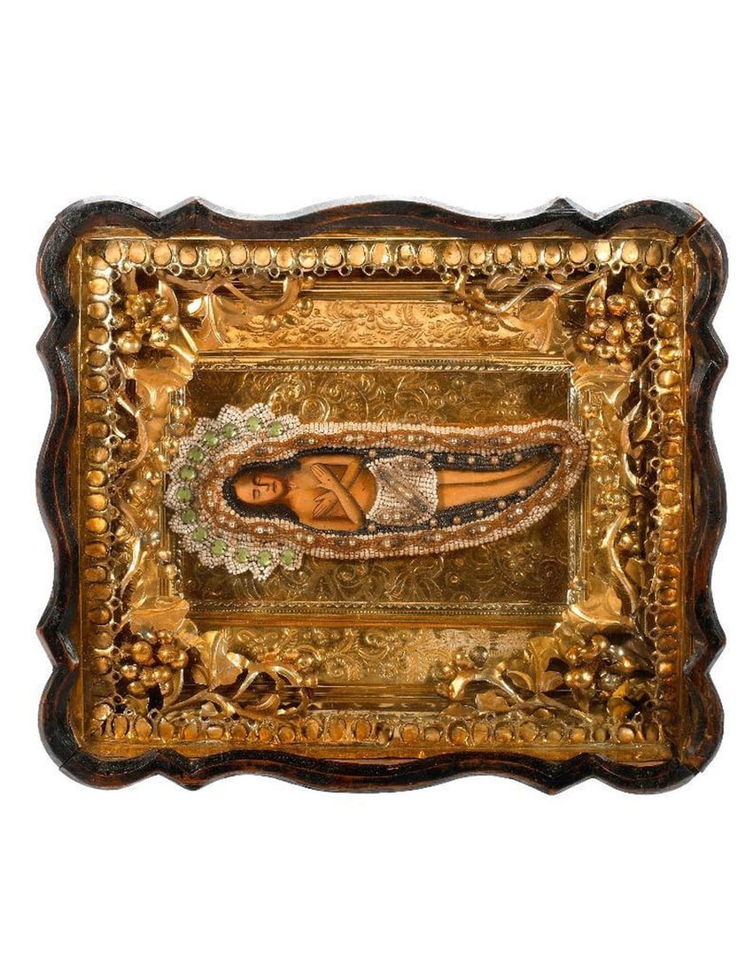 An Icon of Christ with Beaded Shroud, in Kiot.: Eastern Europe, 19th/20th Century. An icon of the Body of Christ (Epitaphios), painted on wood, with beaded and faux jeweled shroud, on foil oklad with ornate foil liner in scalloped shadowbox frame/k