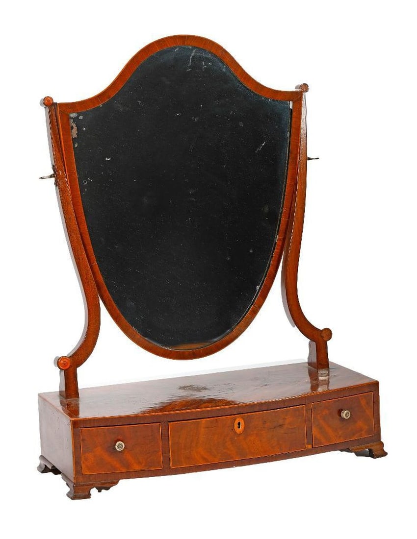 A Shield Mirror Vanity Stand, 19th Century.: The stand of inlaid veneer with a central locking drawer (with key), and two bone-knobbed drawers, mounted with a shield-shaped mirror. 25" H x 18 1/2" W x 8 1/4" W. Condition: overall good; some crac