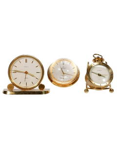Three Swiss Brass Desk Clocks: 1.) Observator8 days brass and two-sided orb-form glass desk clock, 17 jewels, Swiss made. 2.) Gubelin brass alarm clock on stand, Swiss made, 15 jewels. 3.) Semca miniature brass alarm clock, Swiss m
