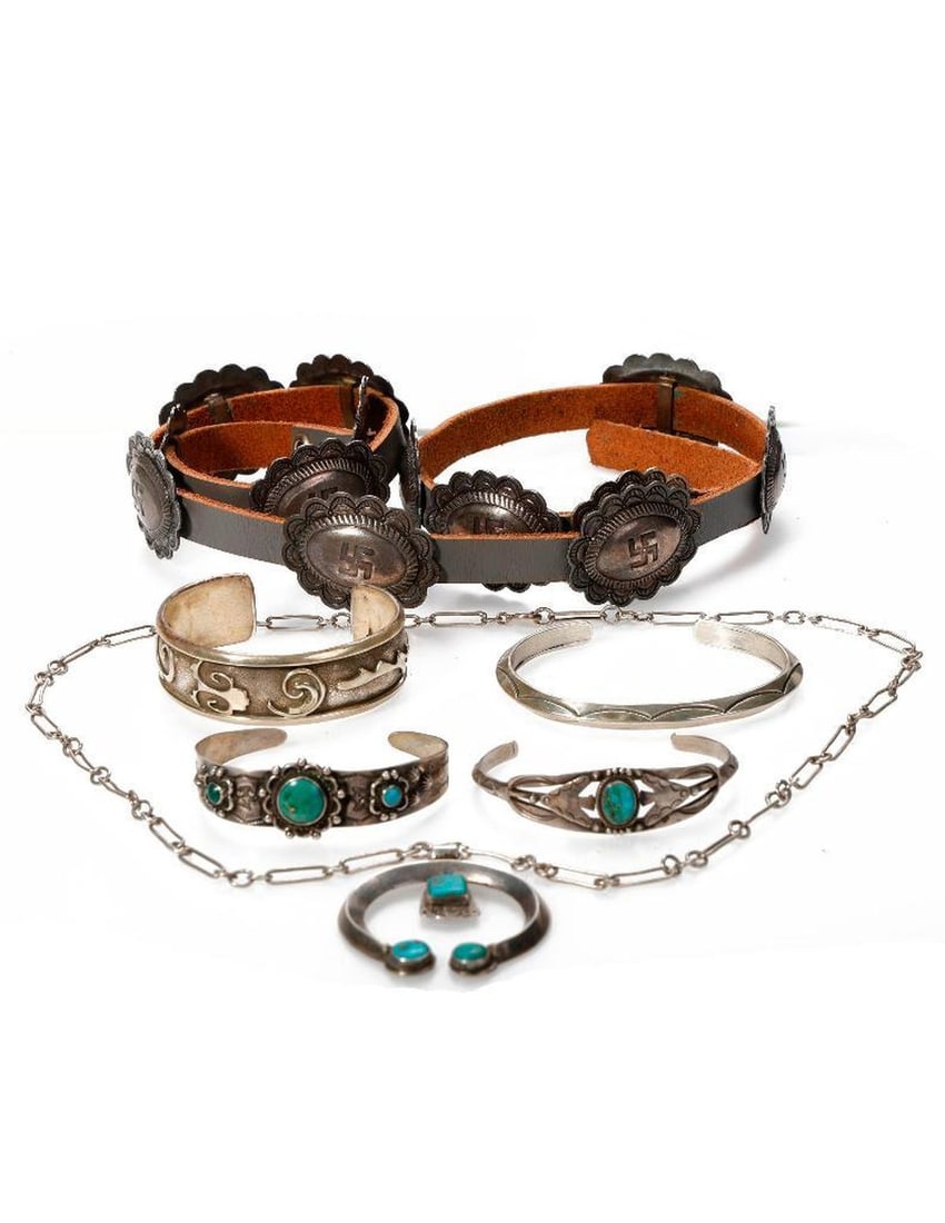 A group of Southwest turquoise and silver items: including a concho belt of whirling logs design, four cuff bracelets, and a squash blossom pendant on chain; gross weight of jewelry: 119.0 grams; overall belt length: 36in.