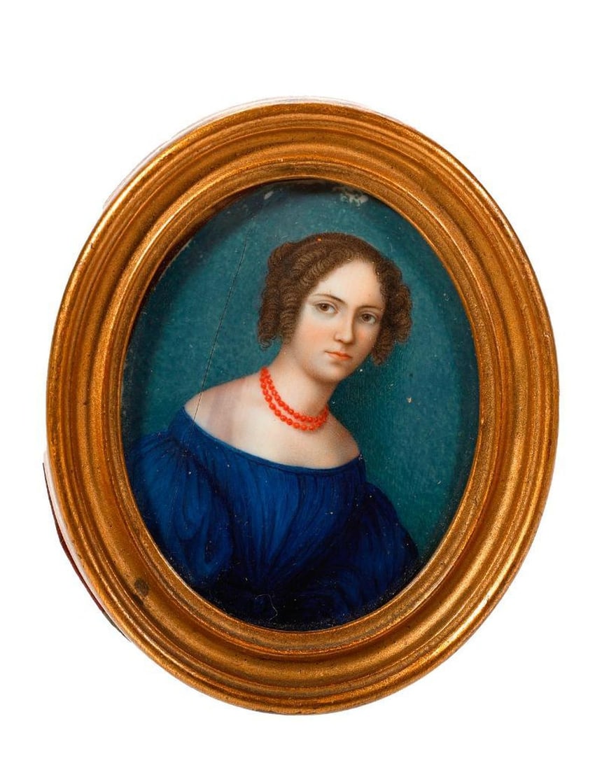 Miniature Portrait of a Lady in Coral Necklace, 1835: A miniature painted portrait depicting a young lady in a blue dress and coral bead necklace. Signed along right margin: A. d'Oroille, fecit 1835. 2 1/4" x 1 7/8" oval (frame 3" x 2 1/2"). Condition: t