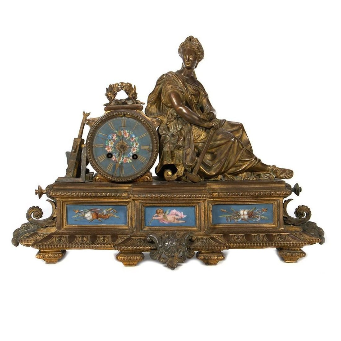 French Gilt Bronze Mantel Clock: Depicting a Goddess surrounded by attributes of industry above a painted dial. 14in. (36cm) h. 18in. (48cm) l. Condition: Loss to gilding. crack across dial. Lacking pendulum