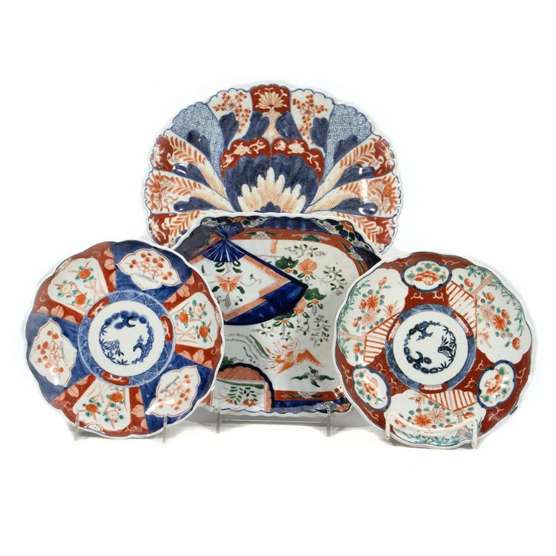 Group of 4 Japanese Imari Dishes: Late 19th Century. All are unmarked; all have rim chips. Measurements: two are 8 1/2" diam. (one with hairline crack); 9 3/4" x 9"; and 12" x 10 1/2" (1 1/2" rim chip/loss).