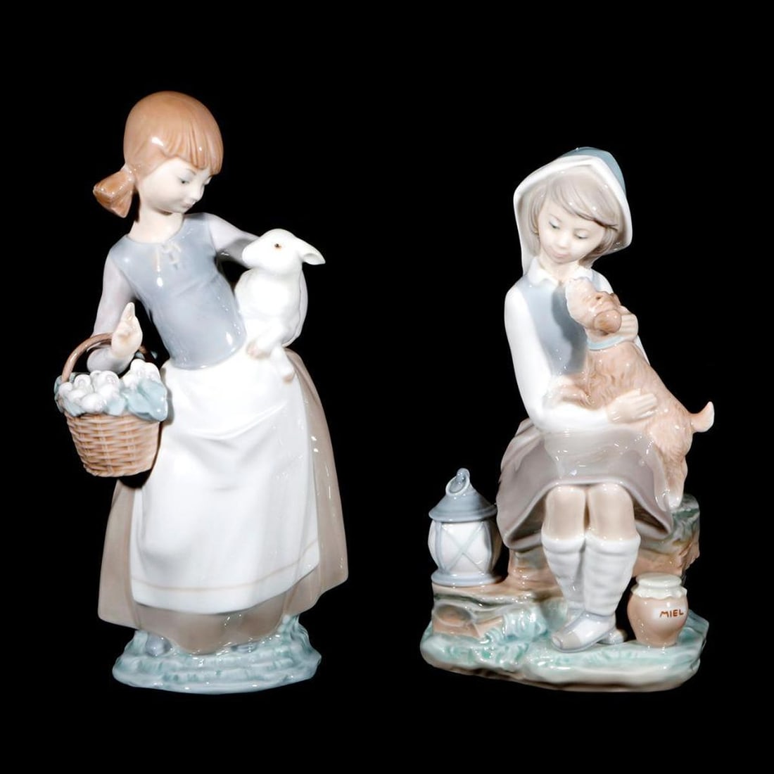 Two Lladro Porcelain Figurines: Two Lladro�Spanish porcelain figurines: a seated girl with a dog, and a standing girl with lamb and basket; both marked. The tallest�measuring 9 1/2 inches high. Good condition.