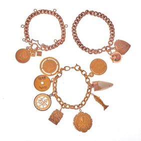 Three gold charm bracelets