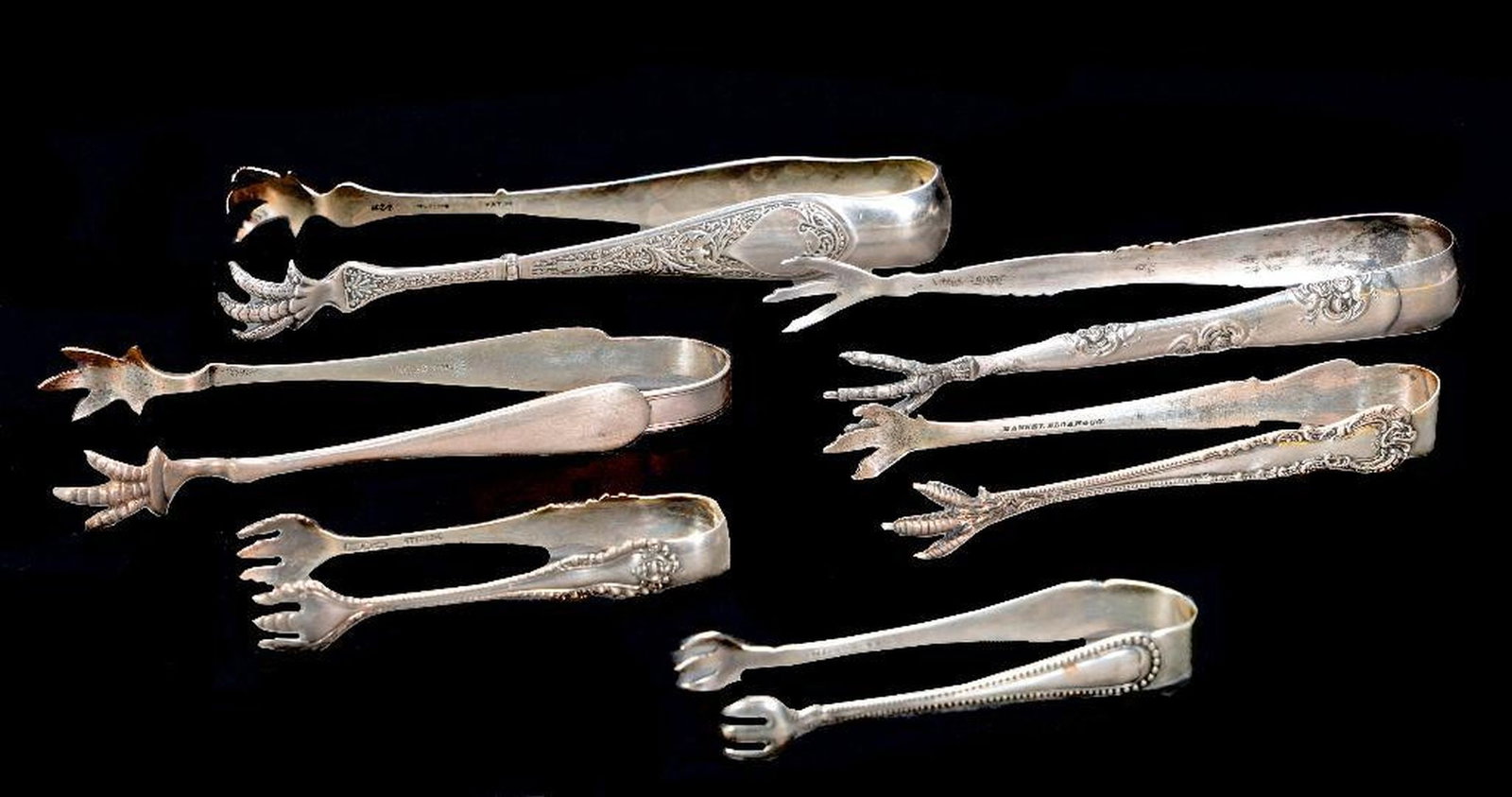 Collection of 6 Silver Ice/Sugar Tongs: The largest tongs are monogrammed. Marks include "Hansel Sloan & Co."; "R.W. & S"; and "W[in circle held by griffin]". Ranging from 3 1/4in. to 5 7/8in. long. Approx. total 160 grams Condition: All pi