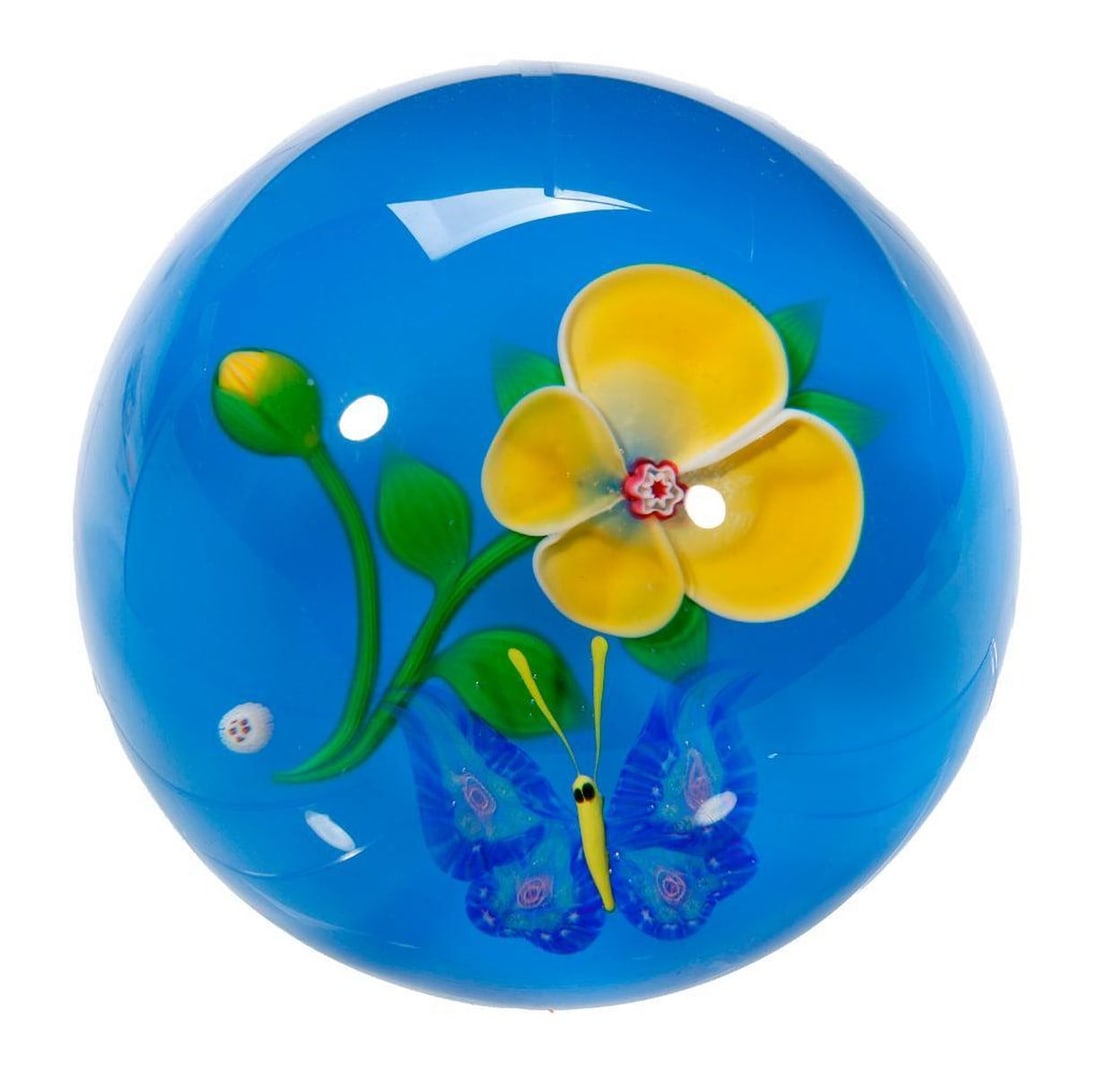 Baccarat Yellow Pansy and Butterfly Paperweight, 1984: An art glass paperweight with yellow pansy and butterfly on blue ground; acid-etched on base, limited edition of 28/175, Baccarat, France, dated 1984; cane mark of 98 1B4.