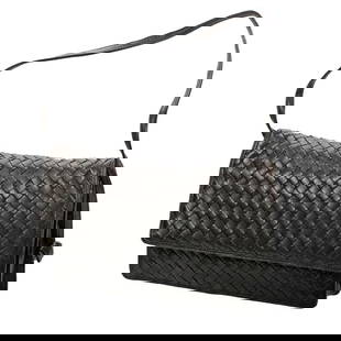 Bottega Veneta Intrecciato Leather Small Shoulder Bag: The Bottega Veneta, Made in Italy labeled small bag of woven black leather, with shoulder strap, snap closure. 7" x 10 1/2". Very good vintage condition; light edge scuffing. With dust bag.