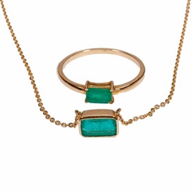 An emerald and 14k gold necklace and earring set