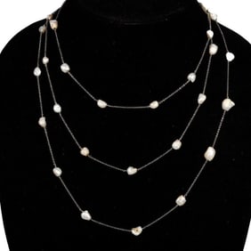 An art deco freshwater river pearl & platinum long chain8.40 x 7.9 to 6.8 x 3.7 mm; weighing
