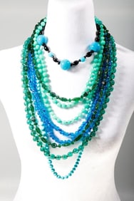 A group of glass bead necklaces