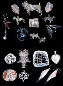 A group of silver jewelry and objects