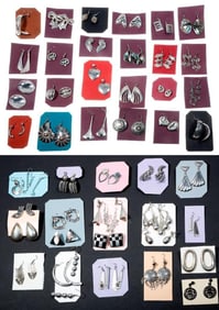 A group of silver earrings