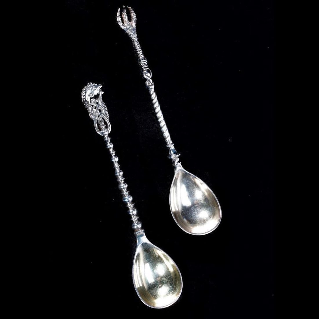 Russian Silver Mythical Spoons, by Mikhail Grachev: Mikhail Grachev, St. Petersburg (1907-1926). Pair of 84 silver marked spoons, one with a mythical horse finial, the other with a dragon's claw. 7 1/4" long. Approx. 149 grams.
