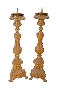 Pair of Baroque Style Altar Prickets: A pair of repousse gilt-brass/metal altar prickets, 23 1/2" high. Condition: each with some denting/wear.