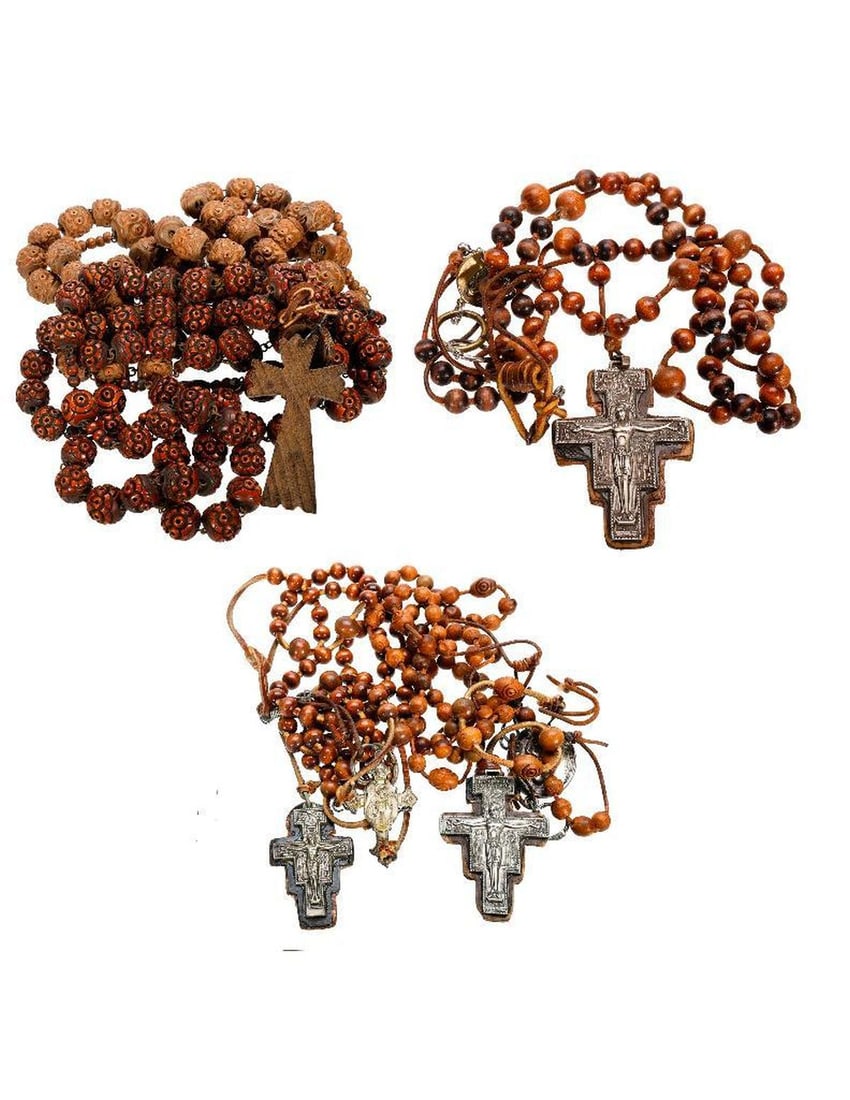 A Collection of Vintage Wood Rosaries: The group consists of a French souvenir Lourdes rosary strand of large carved wood beads, with cross and medallion; hanging approx. 47" long; and an incomplete/broken strand of similar beads. Together