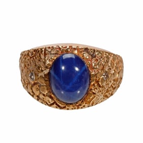 A synthetic star sapphire, diamond and 14k gold ring